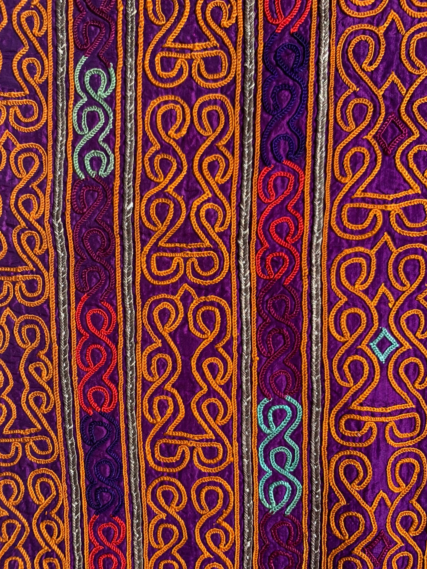 TEXTILE WITH ORANGE EMBROIDERY