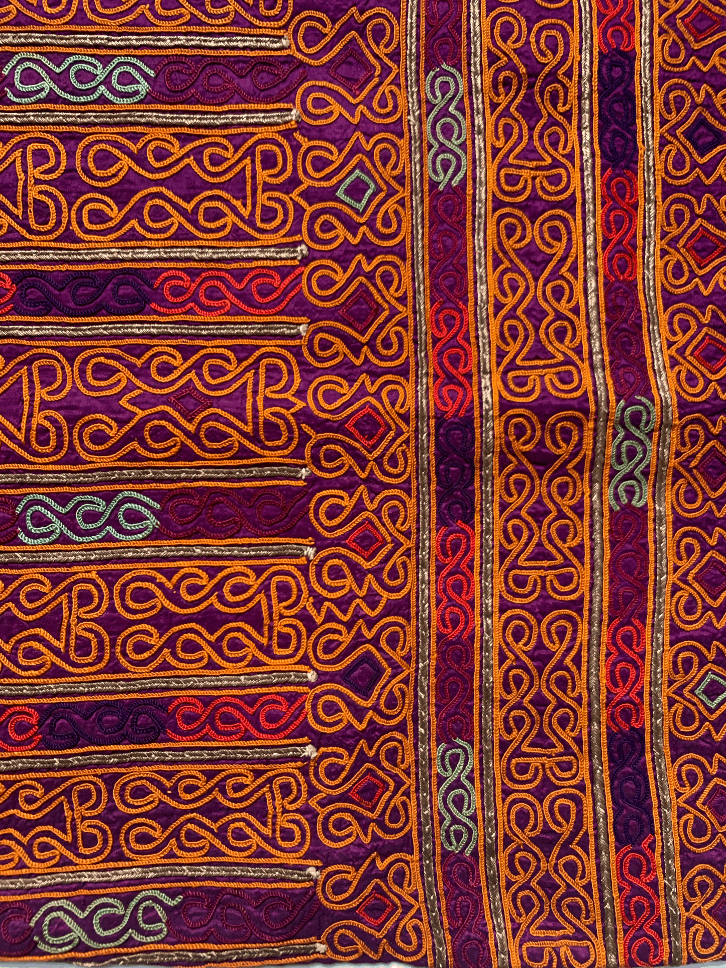 TEXTILE WITH ORANGE EMBROIDERY